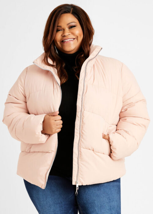 Plus-sized Black woman in pink quilted jacket